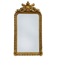 Ornate gilt wood wall mirror, with carved frame and topped with a pair of cherubs holding a medallion. Highly decorative mirror in the 'Georgian' style, perfect in a hall, over a fireplace in a living room or as a stunning addition to your bedroom or dressing room. These ornate wall mirrors work well in a period country home as well as adding that luxurious touch to a town home.

H: 180 cm W: 100 cm D: 16 cm