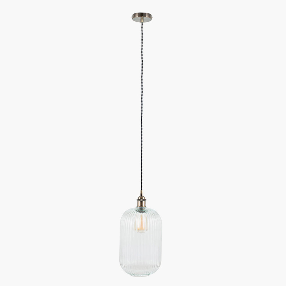 Tall, clear, ribbed glass pendant with brass fittings. A tall glass pendant for the hall, stairwell or in a pair over a kitchen island