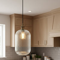 Tall, clear, ribbed glass pendant with brass fittings. A tall glass pendant for the hall, stairwell or in a pair over a kitchen island