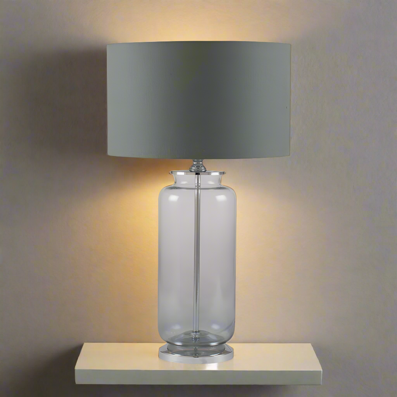 A contemporary grey glass lamp with an ombre shading to the base.&nbsp; It comes with a neutral coloured round linen shade. An easy way to add light and texture to any room.