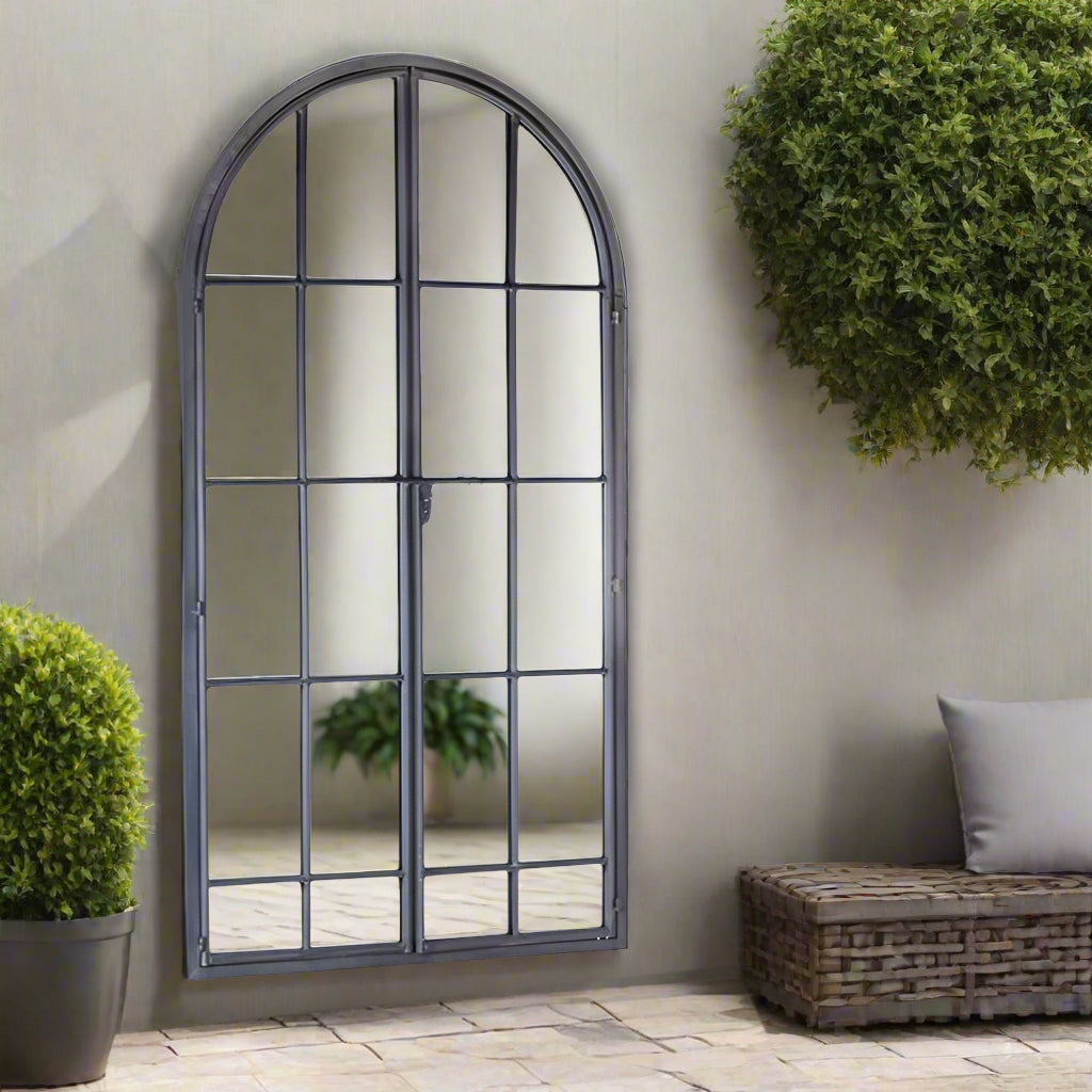 Window mirror in an antique grey metal finish with 2 doors latched in the front of the mirror.
Arched window mirrors, classic garden mirrors adding the illusion of light and space to the wall of any room.