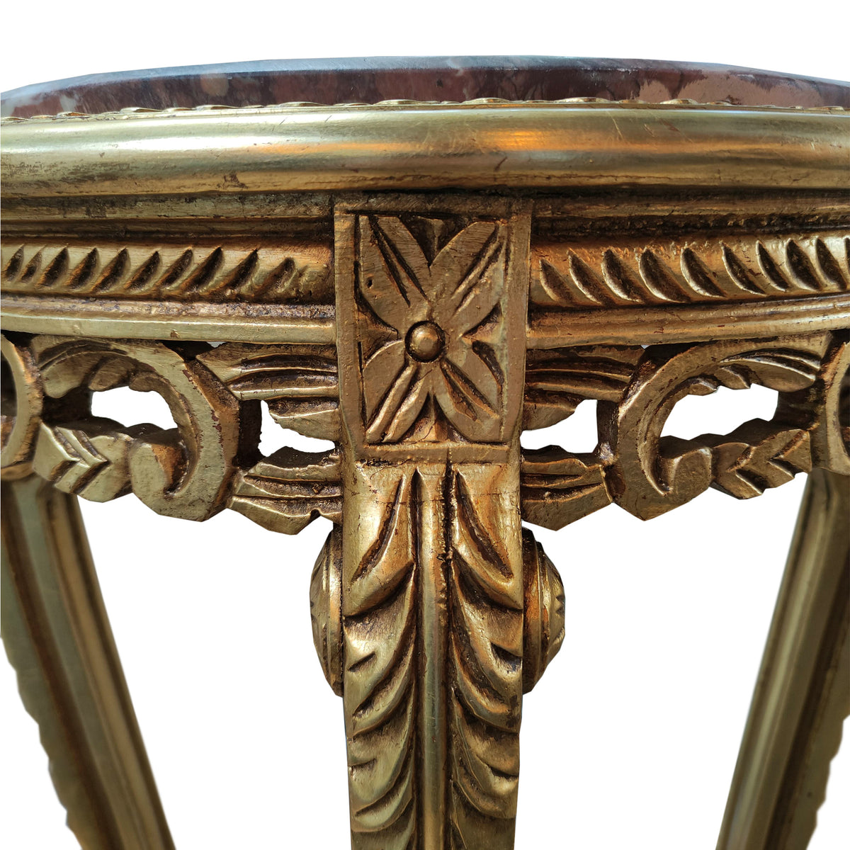 Ornate curved gilt wood based stand with marble top in a Louis style.&nbsp; The base is richly carved and covered in gold, the veined red marble is inset into the top of the stand.&nbsp; The stand has four slender cabriole legs, fluted and carved with acanthus leaves and classical motifs. The legs are then connected with a gilt stretcher to add stability. These stands are used to display a highly decorative work of art or can be used as plant stands. They will lift any room in which they are placed and work