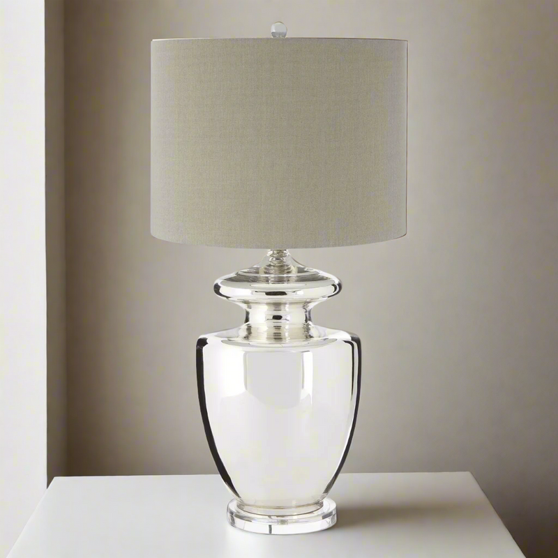 Tall, classic, glass urn shaped table lamp with a round neutral lampshade, a really clean, contemporary feel. Classic shape with a contemporary twist.