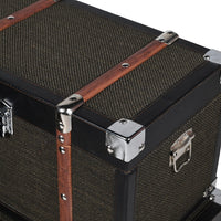 Set of four black trunks in varying sizes.&nbsp; The three larger trunks are banded with wooden straps and nickel studs. Trunks are such a useful item of furniture, perfect for storage but can also be used as a side table in a living room, bedroom study or for storing shoes in a hall. The black hessian covering will work in so many interiors