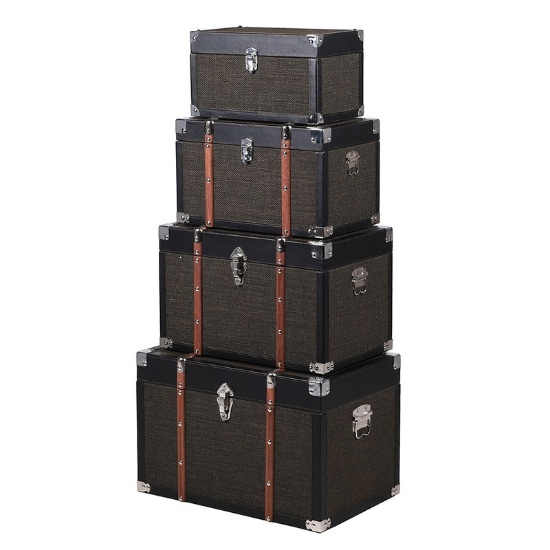 Set of four black trunks in varying sizes.&nbsp; The three larger trunks are banded with wooden straps and nickel studs. Trunks are such a useful item of furniture, perfect for storage but can also be used as a side table in a living room, bedroom study or for storing shoes in a hall. The black hessian covering will work in so many interiors