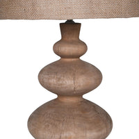 Turned mango wood table lamp with linen shade. A stunning lamp base that will fit into so many interiors, whether classic country or urban industrial, this lamp would work. In a sitting room, hall or dining room, this decorative wooden base and natural linen shade would look amazing.