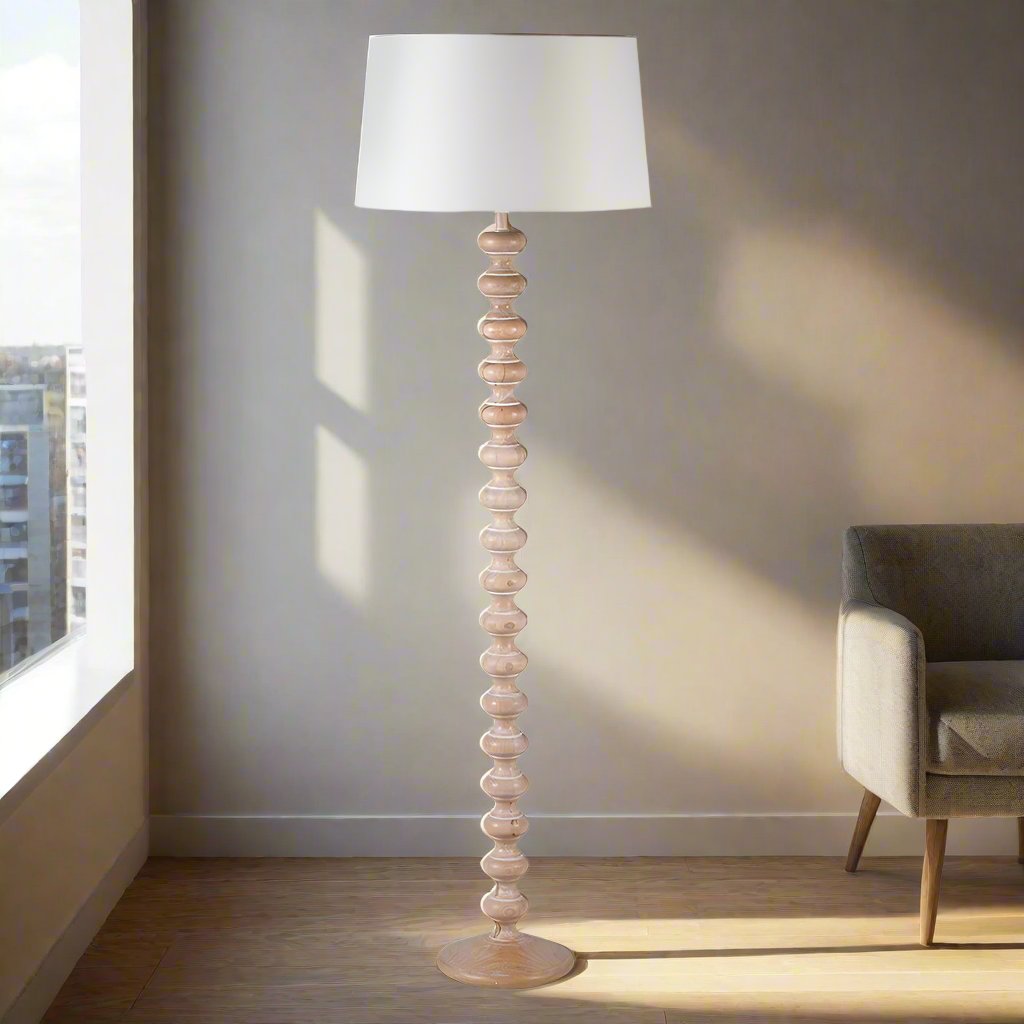 Turned wooden floor lamp, in a natural wood. A great Scandi look with white linen shade. A simple contemporary lamp. 
