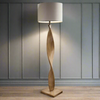 Pale wooden curved floor lamp, great in a Scandi interior.&nbsp; The design is exceptional in a living room or hall the pale linen shade allows light to our out.