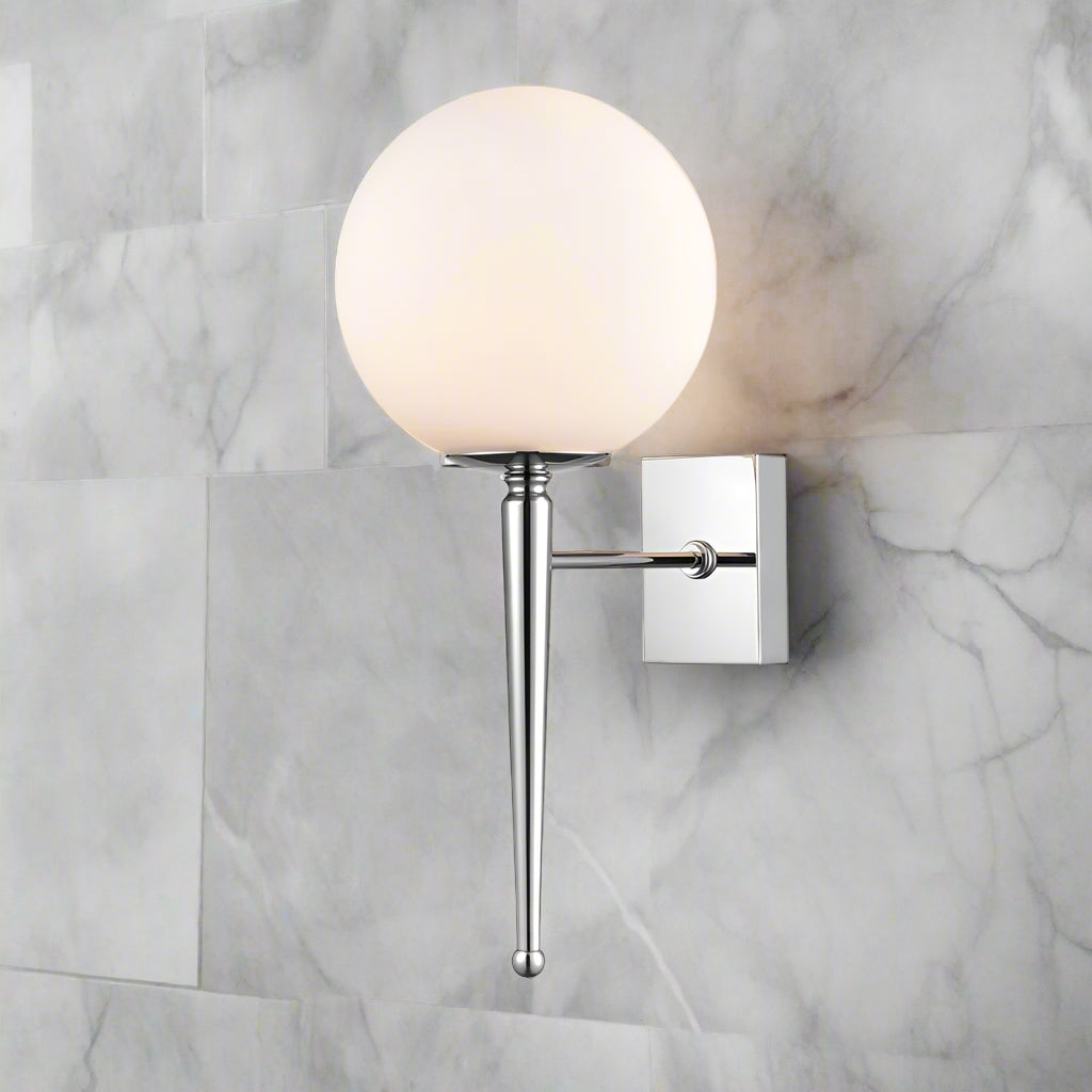 Elegant opal glass wall light on a chrome metal arm and plate.&nbsp;&nbsp; Works wonderfully in bathrooms on either side of a mirror above your sink or vanity unit.


H: 44 cm W: 18 cm