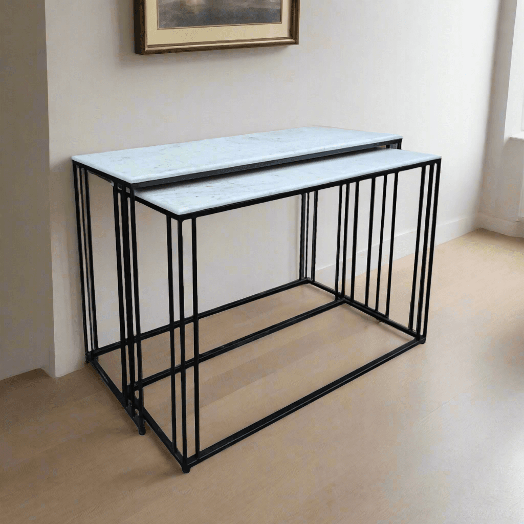 Marble topped console tables on a black iron metal base. These sturdy pieces where the white marble contrasts stunningly against simple black iron legs. 