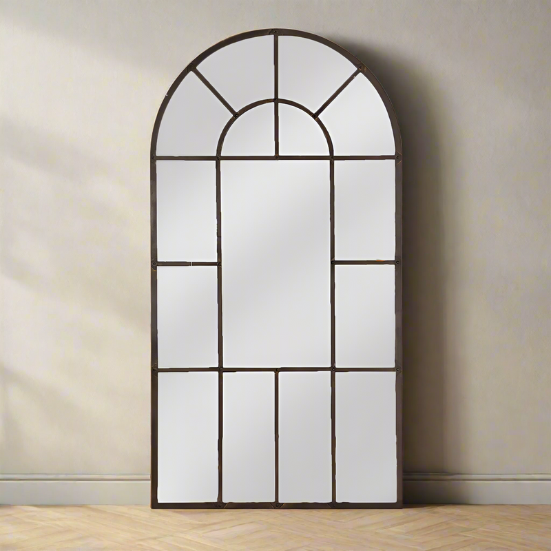 One of our largest bronze black metal window mirrors designed to reflect light back into your space and give you the illusion of having twice the space you really have.&nbsp; An arched design super tall and wide, this beautiful mirror will soften a space and be a striking feature in any room.