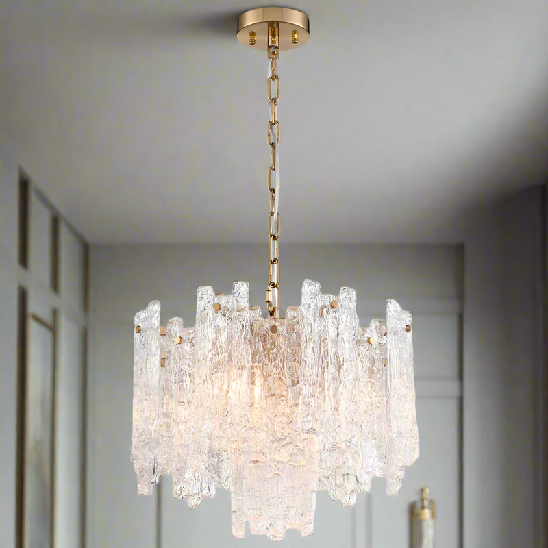 Icicle shard chandelier with textured glass panels at varying heights to refract the lights. It has 5 lights and aged brushed brass metal fittings. Perfect sitting room chandelier, a glamorous, statement light.