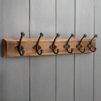 Bring practical storage to your hallway, entryway or bedroom with this rustic wooden wall-mounted coat rack. Crafted from solid wood and fitted with six durable black metal double hooks, it offers ample space for coats, jackets, hats, scarves, bags, and everyday essentials.