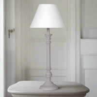 A slim simple bedside table lamp.&nbsp;&nbsp; A grey wooden turned base with a light fabric shade. Perfect for the smaller table top. 