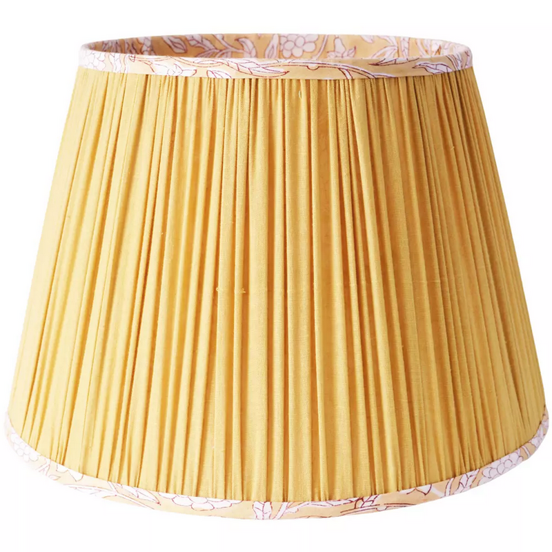 Soft Yellow Tapered Cotton Lamp Shade.
Bring warmth and elegance to your home with this pleated yellow lampshade. Crafted with fine fabric and subtle detailing, the soft pleats create a classic silhouette that diffuses light beautifully, casting a golden glow in any space. The trim is delicately patterned, adding a touch of character while keeping the design versatile and timeless.
Perfect for both modern and traditional interiors, this lampshade fits most table and floor lamps, instantly refreshing your 