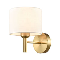 Aged brass wall light with round cream fabric shade