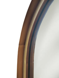 Aged bronze metal frame detail on arched mirror