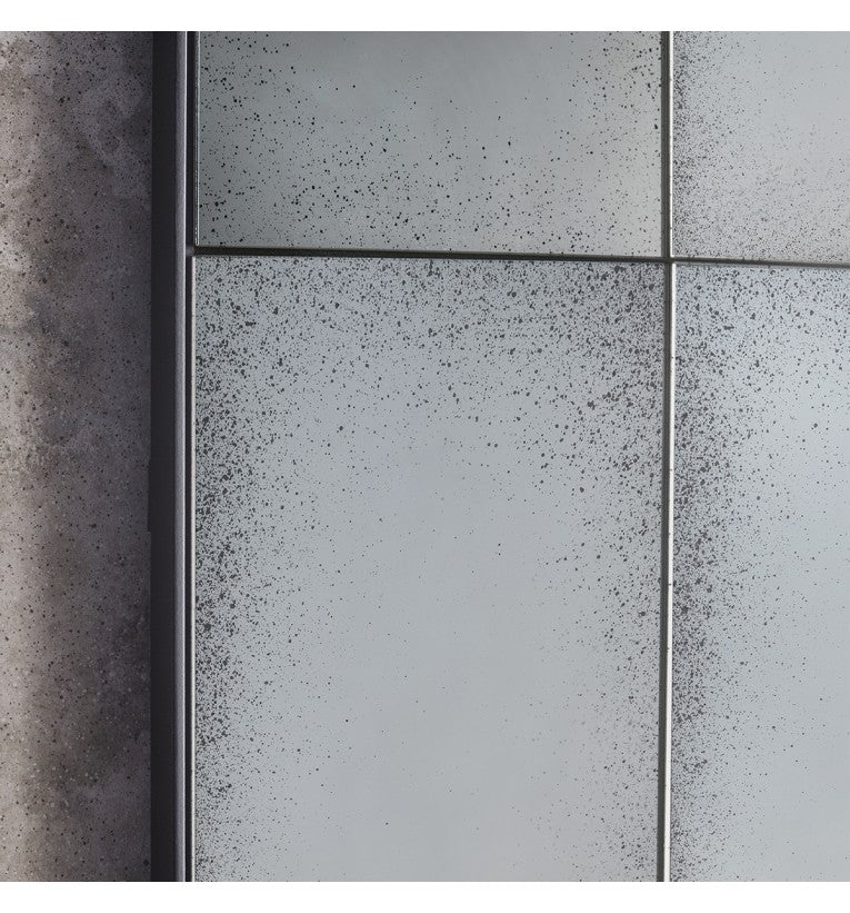 Close-up of the aged glass grid panels on the window mirror