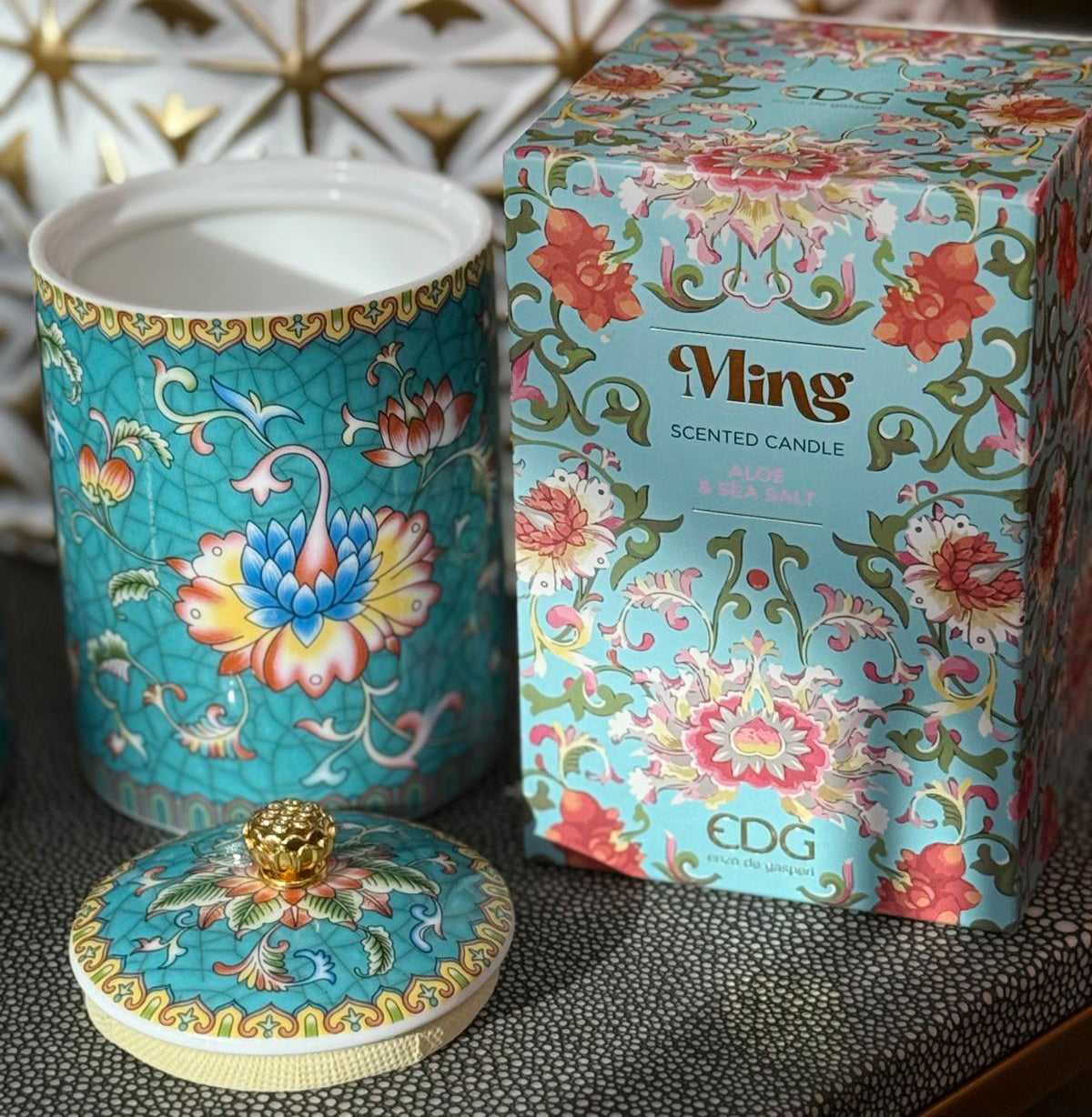 Handcrafted ceramic candle jar with turquoise floral design and gold detailing, scented with Aloe and Sea Salt.