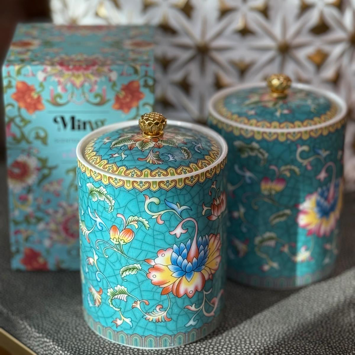 Handcrafted ceramic candle jar with turquoise floral design and gold detailing, scented with Aloe and Sea Salt.