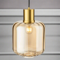 Large amber glass pendant light with brushed gold metal top, a muted colour to add a glow to your room, perfect as a kitchen island light. This particular pendant is available to view in the Chiswick Store. Glass pendant lighting is perfect for use in kitchens.