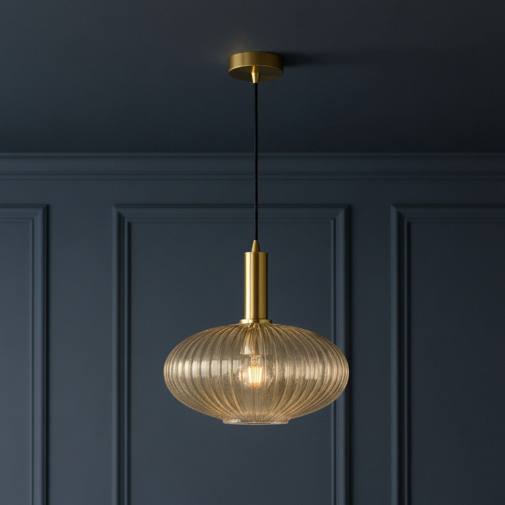 Amber ribbed glass and brushed gilt metal fitting in  a classic paneled room and ceiling.