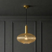 Amber ribbed glass and brushed gilt metal fitting in  a classic paneled room and ceiling.