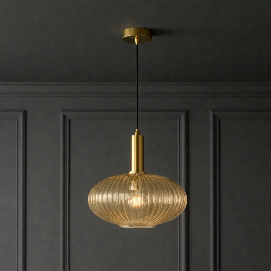 Amber ribbed glass and brushed gilt metal fitting in  a classic paneled room and ceiling.