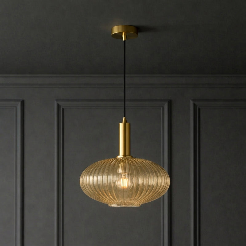 Amber ribbed glass and brushed gilt metal fitting in  a classic paneled room and ceiling.