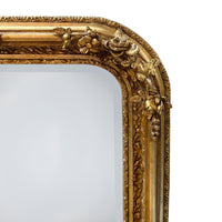 Make a grand statement with this exquisite Large Ornate Gold Overmantle Mirror, a luxurious piece designed to bring timeless elegance and opulence to your interior.

Crafted with intricate detail, the mirror features a richly carved frame adorned with floral garlands, scrollwork, and a central crest displaying classical motifs — evoking the romantic grandeur of the Louis XVI era. The generous rectangular shape, softened by elegantly curved corners, offers both functionality and decorative impact.

Over a fi