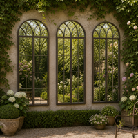 Three large arched window mirrors on a garden wall reflecting a mature garden with bench and pots. 
