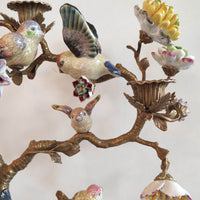 Decorative wall piece with ceramic birds and flowers on a white background