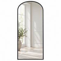 Simple black arched mirror in a white room.