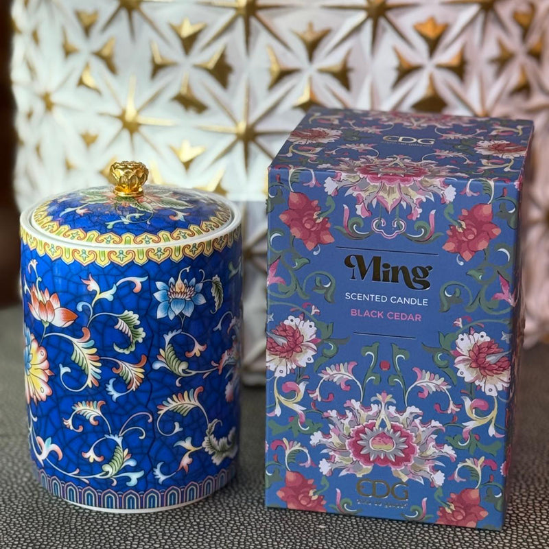 Handcrafted blue ceramic scented candle jar with floral design and gold detailing, scented with Black Cedar.