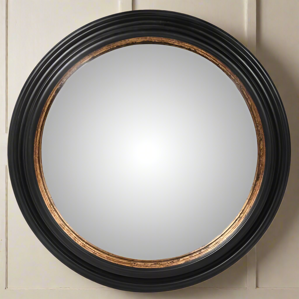 Large round black convex wall mirror with an antiqued gold inner ring accent on a clean white background.