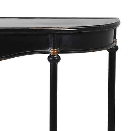 Detail of Metal console table with a slim black metal frame and a gracefully curved silhouette, distressed black finish with delicate gold accents