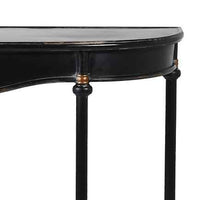Detail of Metal console table with a slim black metal frame and a gracefully curved silhouette, distressed black finish with delicate gold accents