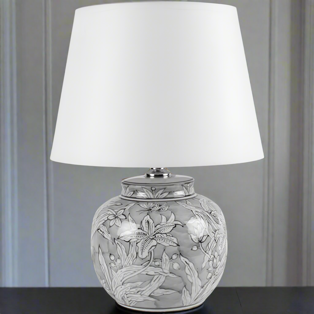 A really pretty, smaller lamp base with white fabric shade, perfect for bedside or on a side table in a sitting room. Really pretty small ceramic lamp with a white fabric shade, and an unusual faded black and white base.