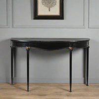 Refined, versatile, and effortlessly elegant, this medium metal console table is the perfect accent piece for modern and traditional interiors alike. Designed with a slim black metal frame and a gracefully curved silhouette, it offers a sophisticated focal point while keeping your hallway or entryway light and uncluttered.
The gently distressed black finish with delicate gold accents adds a touch of vintage character, making each piece feel unique.