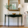 Refined, versatile, and effortlessly elegant, this medium metal console table is the perfect accent piece for modern and traditional interiors alike. Designed with a slim black metal frame and a gracefully curved silhouette, it offers a sophisticated focal point while keeping your hallway or entryway light and uncluttered.
The gently distressed black finish with delicate gold accents adds a touch of vintage character, making each piece feel unique.