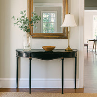 Refined, versatile, and effortlessly elegant, this medium metal console table is the perfect accent piece for modern and traditional interiors alike. Designed with a slim black metal frame and a gracefully curved silhouette, it offers a sophisticated focal point while keeping your hallway or entryway light and uncluttered.
The gently distressed black finish with delicate gold accents adds a touch of vintage character, making each piece feel unique.