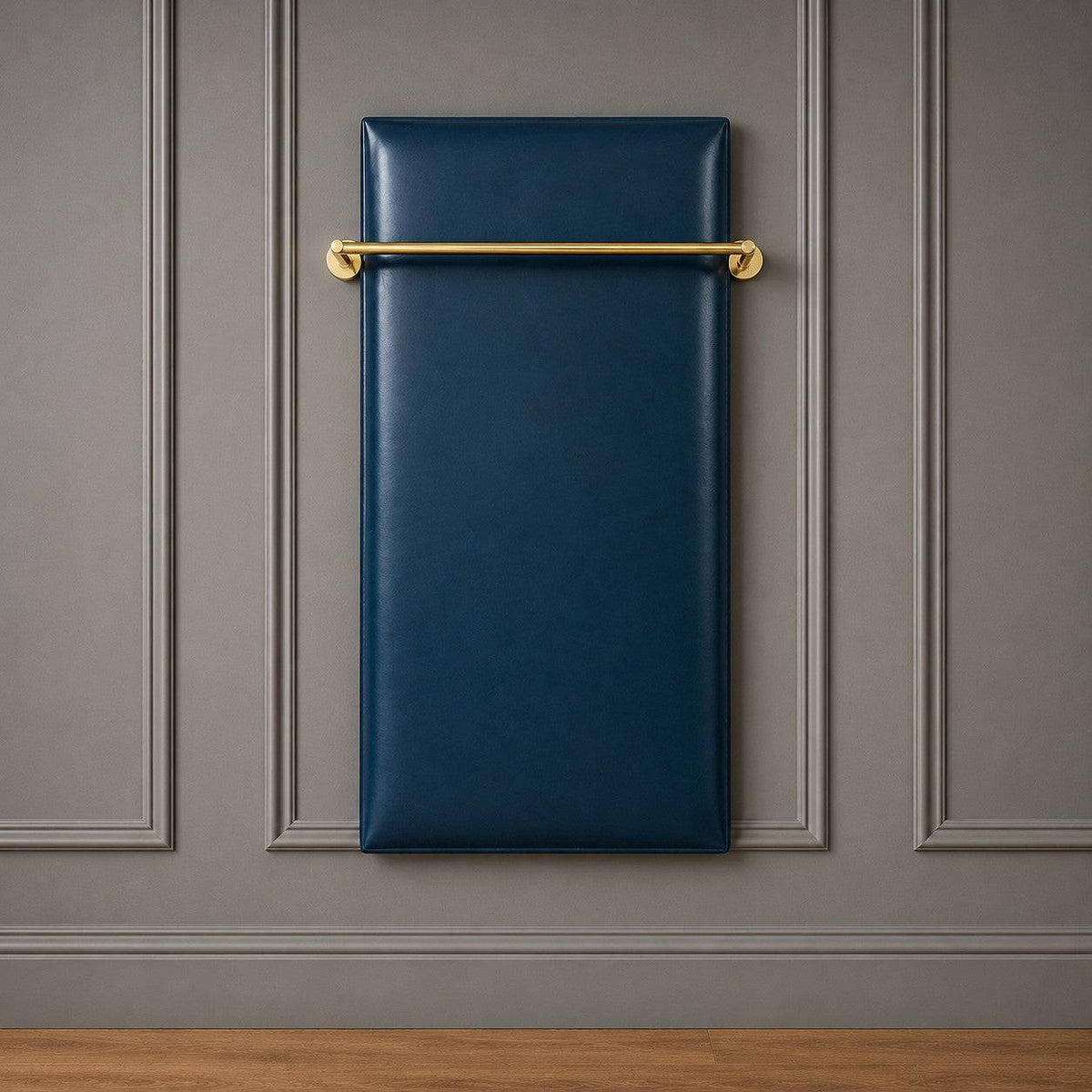 Wall-mounted luxury clothes board upholstered in deep blue vinyl with a polished brass hanging rail against a grey panelled wall.