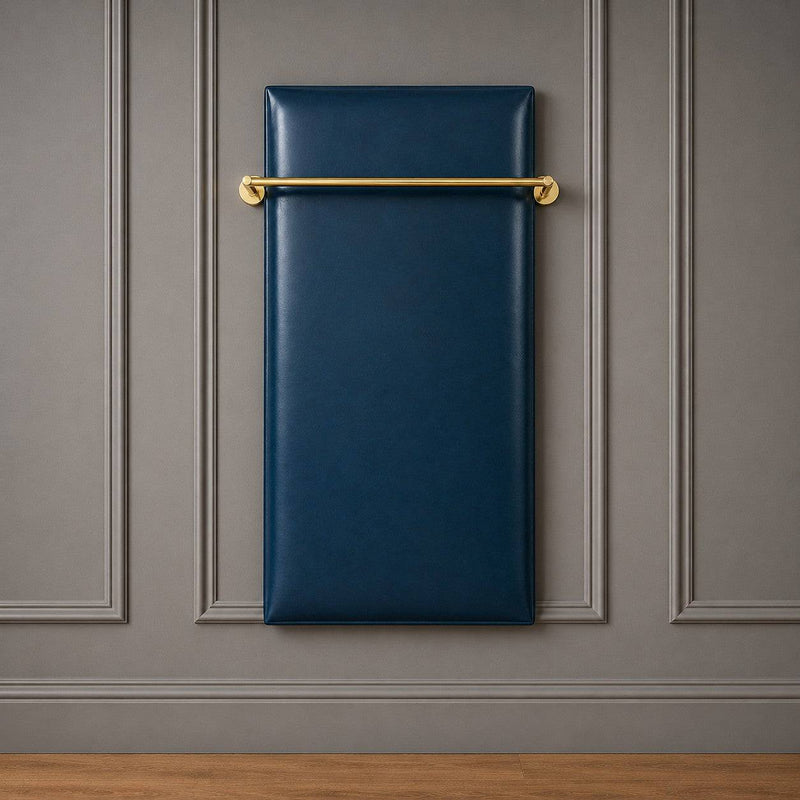 Wall-mounted luxury clothes board upholstered in deep blue vinyl with a polished brass hanging rail against a grey panelled wall.