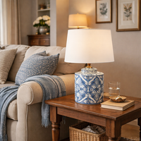 Decorative lamp with blue and white pattern on a wooden table in a living room on side table, traditional style interior