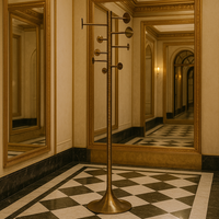 Gold coat rack in a hallway with mirrors and decorative walls
