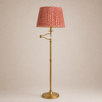 Floor lamp with a red textured shade on a beige background