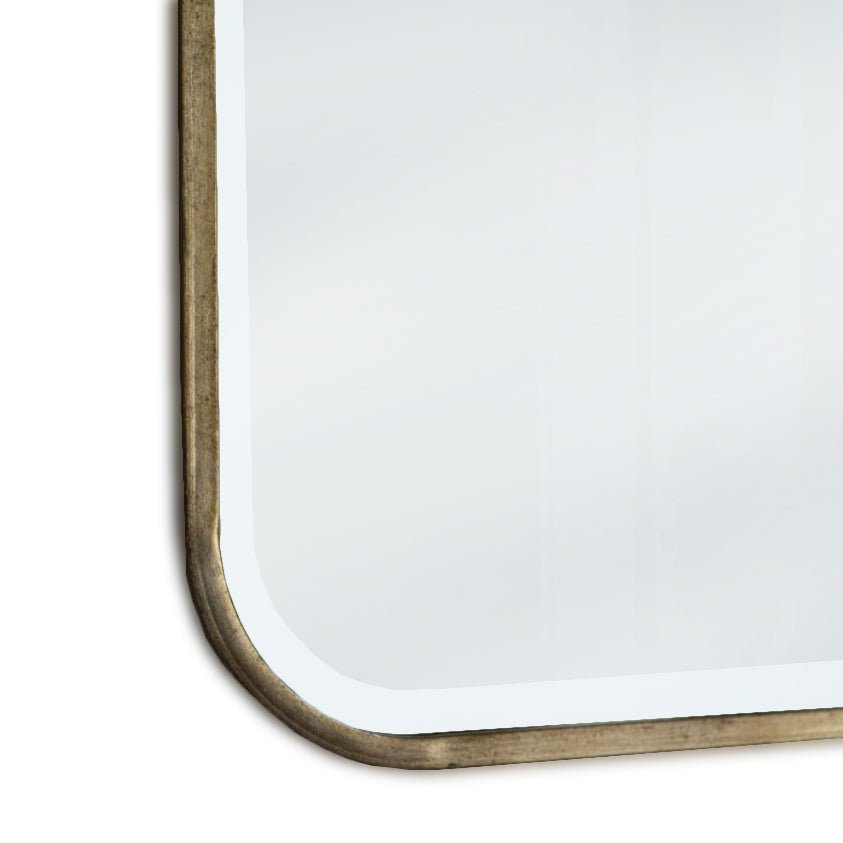 Curved corner and bronze metal frame detail on mirror