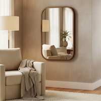 Bronze metal wall mirror with curved corners in a living room