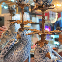Stunning blue and white porcelain parrot candleholders with gilt bronze finials. Exceptional quality — a true statement piece for any room. Close up of tops of the birds.

