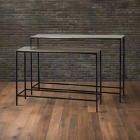 Sleek and sophisticated, this set of bronze-topped console tables pairs a warm metallic finish with minimalist black steel frames for a refined industrial look. The nesting design offers flexible styling — use together for layered depth or separately across your home. Perfect for entryways, living rooms, or modern interiors, these tables bring timeless elegance and functional versatility to any space
